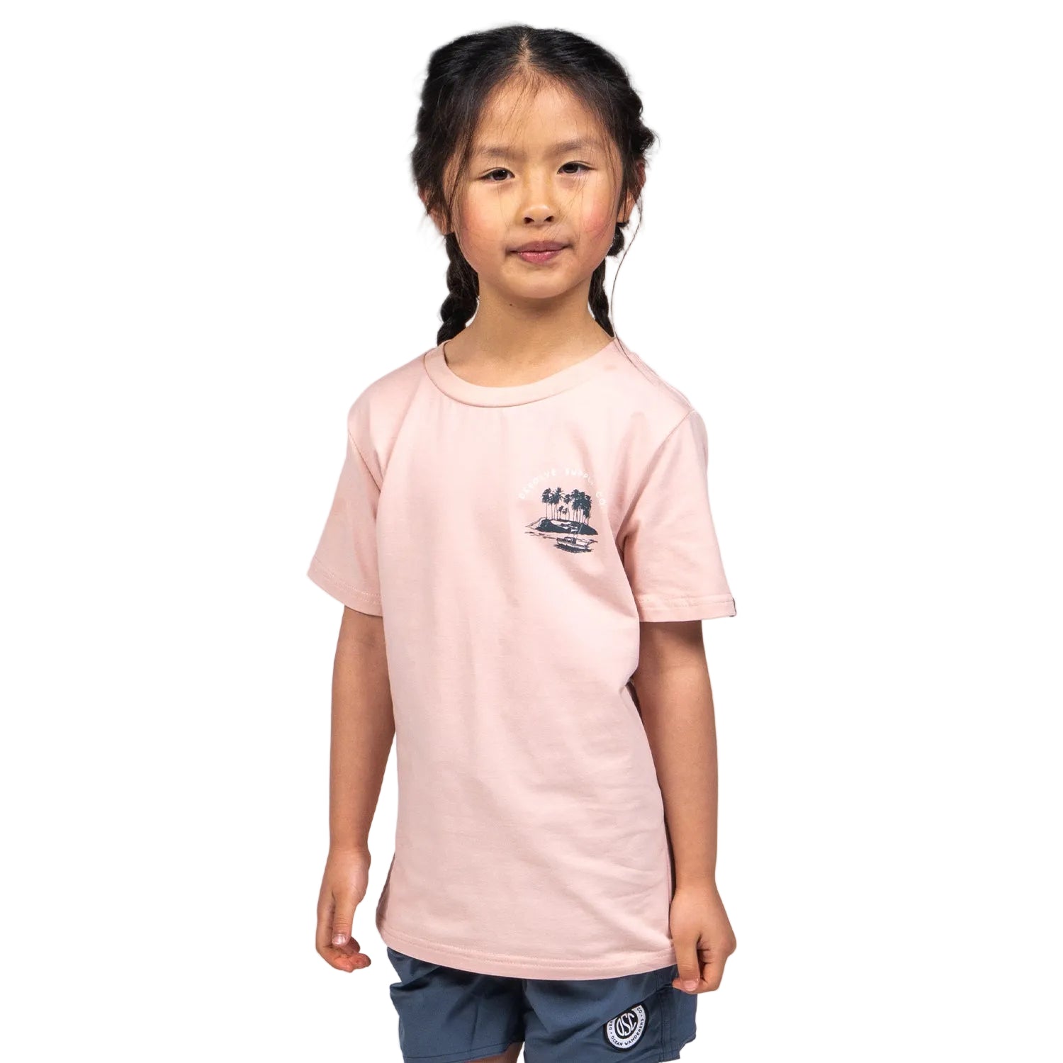 A child wearing a pink T-shirt with a graphic print in the center, standing against a white background.