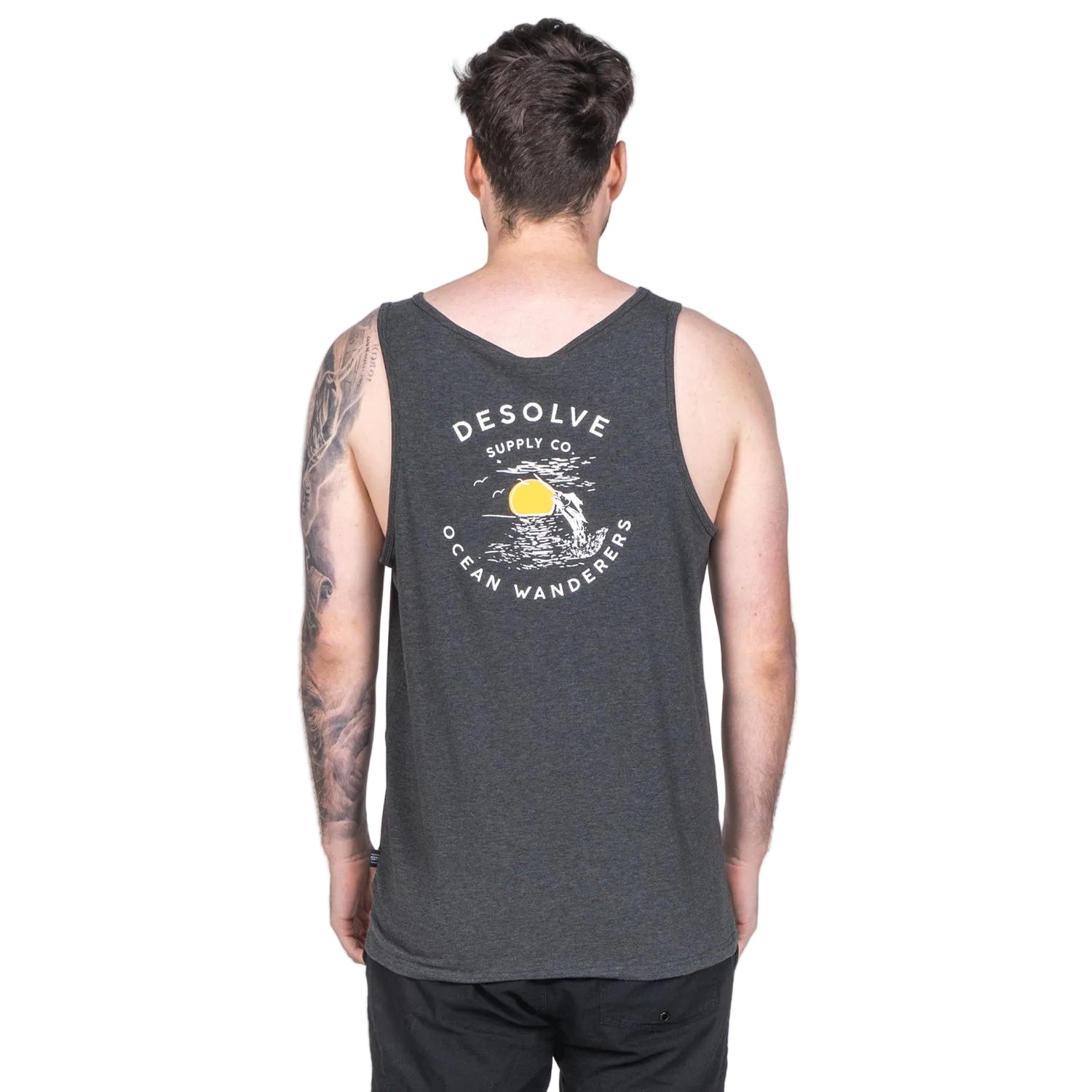 A person wearing a gray singlet tank top with the text 'DESOLVE' and an illustration of a sun and moon on the front.