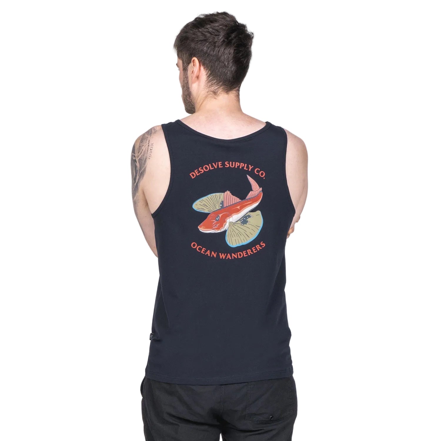 A person wearing a black tank top with a colorful graphic that includes the text 'DESOLVE SUPPLY CO.' and 'OCEAN WANDERER'S', showing a stylized fish and ocean waves.