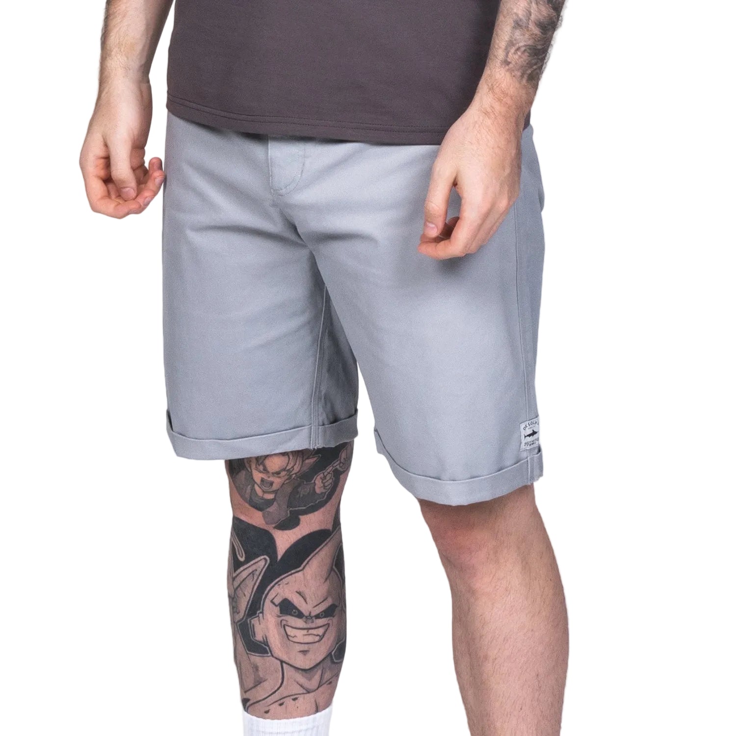 A person standing wearing gray Starboard shorts with two front pockets, two rear pockets, and a belt loop. The shorts have a rolled-up hem and a relaxed fit.